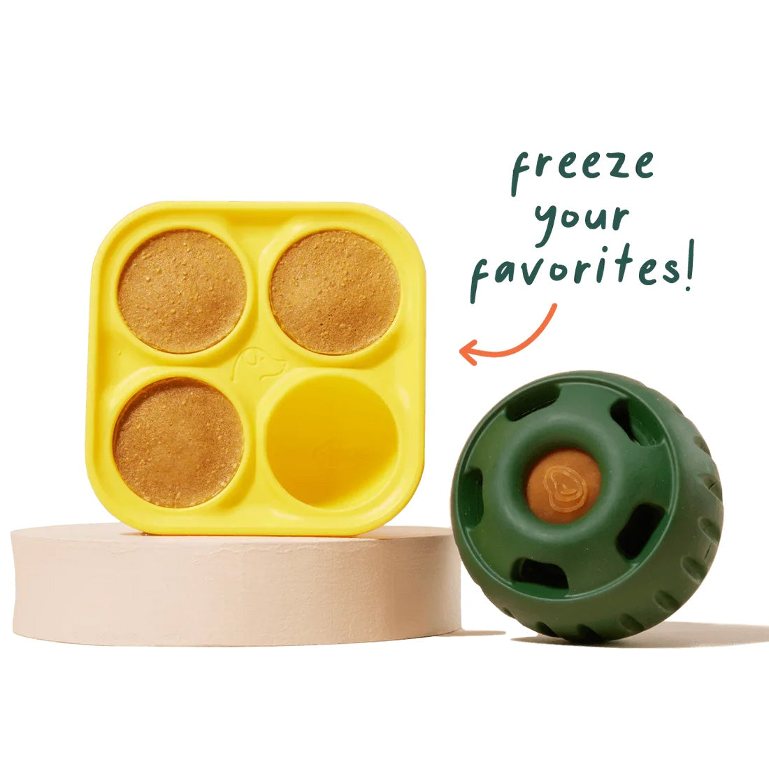 Homemade frozen dog treats made with Woof Pupsicle Treat Tray beside green Pupsicle Toy