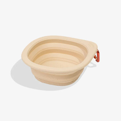 Zee.Dog GoBowl in Biscotti beige shown expanded with an orange carabiner